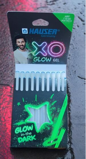 Packaging of Hauser XOX Glow Gel kit with neon green/pink logo and glow graphics, showing rows of gel tubes and a glow-in-the-dark star design.