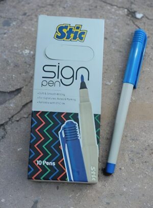 STIC Sign Pen box with a beige pen beside it on a rough concrete surface.