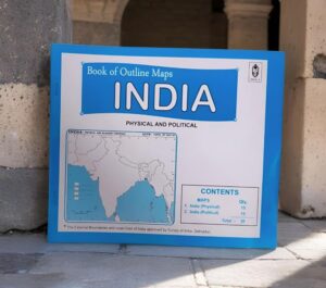 Blue-framed map book cover titled 'Book of Outline Maps INDIA' with a map of India on a white page, placed on a stone surface.