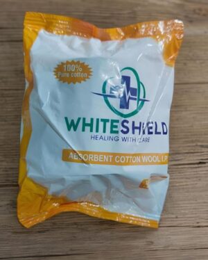 Bag of White Shield absorbent cotton wool on a wooden surface; packaging shows 100% pure cotton label.