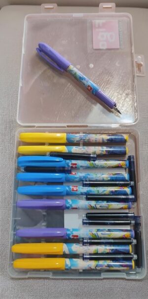 Assorted gel pens in a clear case, including yellow, blue, purple and black pens, laid out in two compartments in two rows.