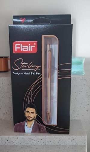 Flair Sterling designer metal ball pen in black box; copper pen visible through window, packaging shows a man’s portrait on the lower left.