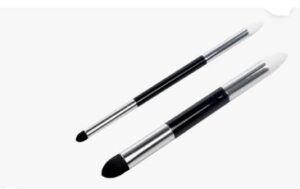 Two makeup brushes with black handles and silver ferrules on a white background, laid diagonally.