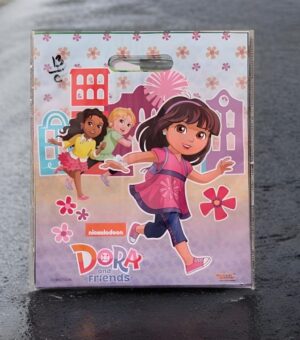 Dora and Friends toy packaging showing Dora running in a pink top with two friends in a colorful cityscape.