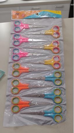 Blister-pack of multiple kids' safety scissors with colorful handles arranged in a column.