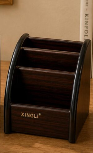 Dark wood desk organizer with three slanted compartments on a wooden surface, branded XINGLI.