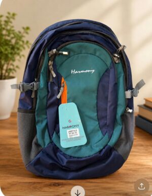 Teal and navy Harmony backpack with multiple zippered pockets and a hanging turquoise price tag on a wooden table.