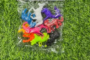 Clear plastic bag on grass containing a assortment of small multicolored plastic dinosaur figurines.