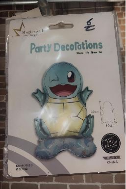 Cartoon blue turtle party decoration on a packaged display reading 'Party Decorations'.
