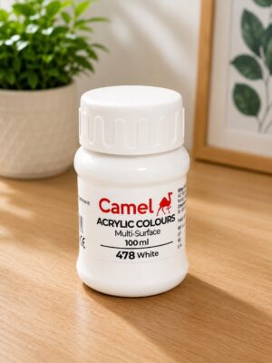 White Camel acrylic colours bottle on a wooden table, label shows 100 ml and color 478 White, with a green plant in the background.
