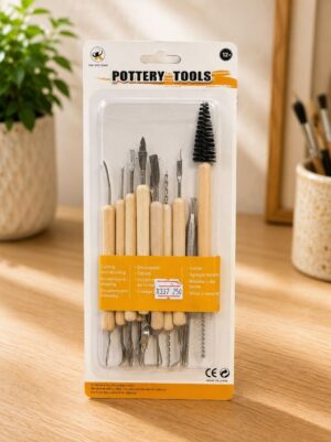 Pottery tools set in plastic packaging with wooden-handled tools and a large brush on a wooden table.