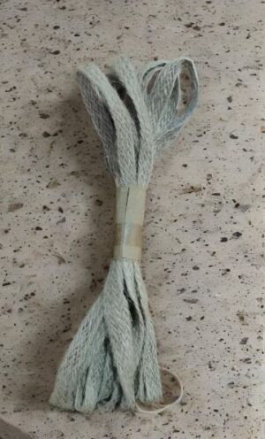 Bundle of light blue rope tied with tape on a speckled countertop surface.