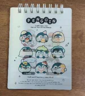 Spiral notebook page with nine cute penguin stickers wearing hats, arranged in three rows, and a 'PENGUIN' title at the top.