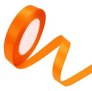 Orange satin ribbon roll with a curling loose end on a white background