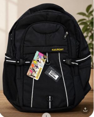 Black Harmony backpack on a wooden surface, front pockets open, with hanging product tags and a yellow Harmony logo patch in view.