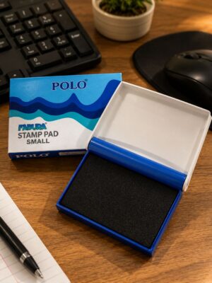 Open blue Polo Fabura stamp pad (small) with black foam, on a wooden desk near a keyboard and mouse.