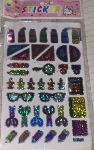 Glitter sticker sheet with assorted colorful shapes (triangles, circles, rectangles) and small icon stickers on a white backing, packaged in a clear sleeve titled 'Sticker' with a pink header.