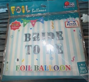 Foil balloon kit that spells 'BRIDE TO BE' with colorful 'Foil Balloon' packaging and pastel blue striped background.