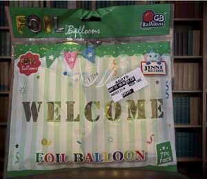 Foil balloon package with green-and-white stripes reading 'WELCOME' in gold letters; packaging shows 'FOIL BALLOON' branding and GB Balloons logo.