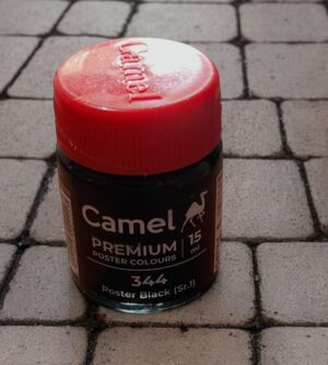 Jar of Camel Poster Colours in Poster Black (344), 15 ml, red cap, on a paved brick surface.