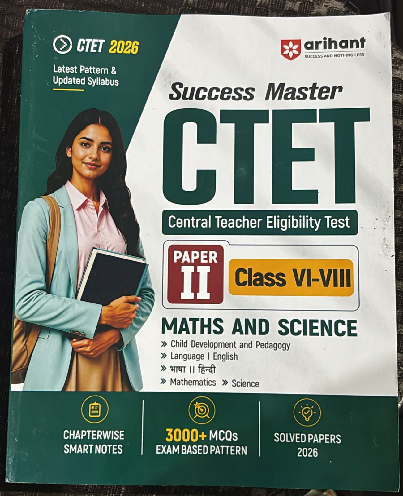 Cover of a student guide titled 'Success Master CTET'; shows a smiling woman in a teal blazer holding notebooks, with 'CTET 2026' and 'Central Teacher Eligibility Test' branding.