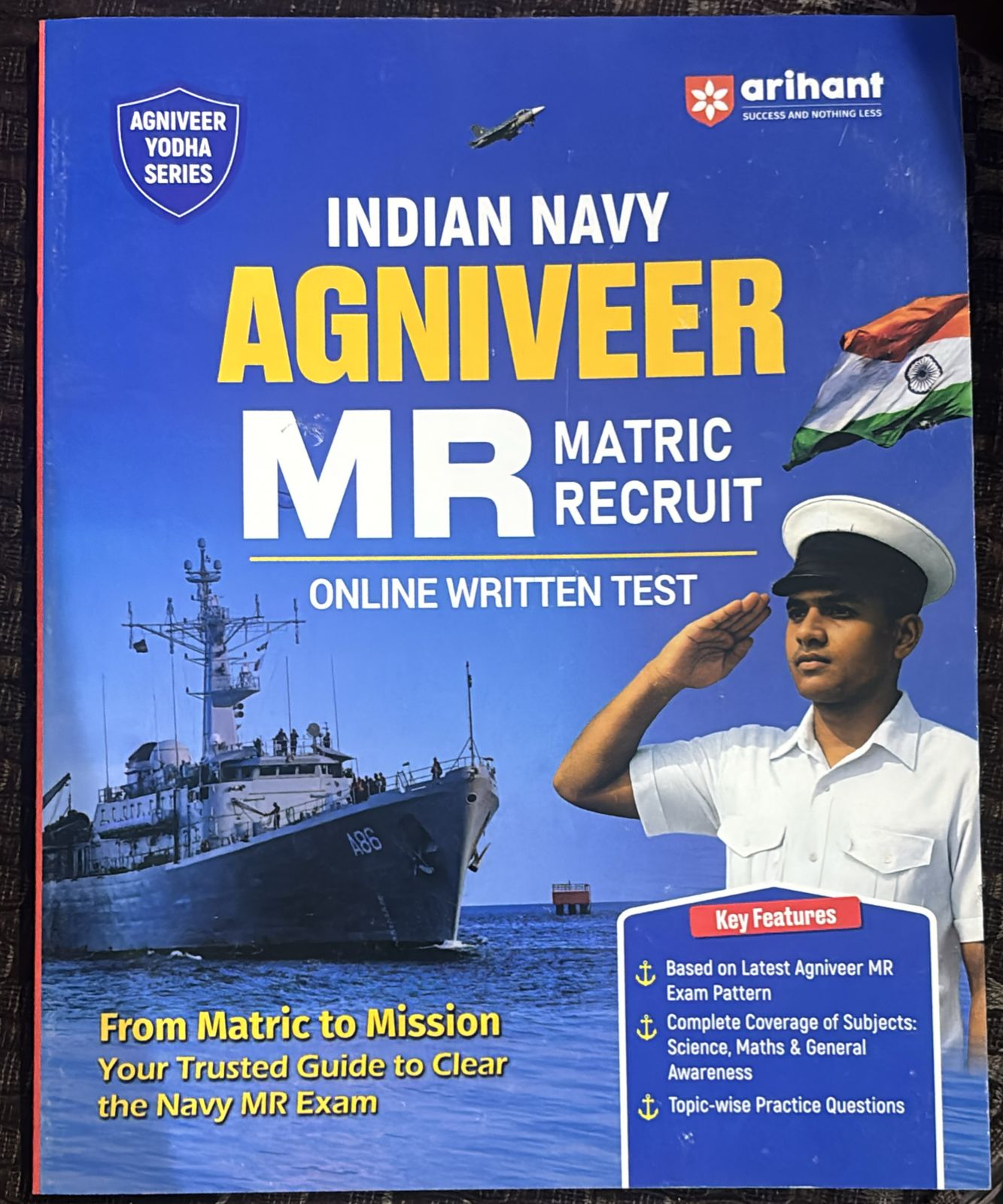 Book cover: Indian Navy Agniveer MR Matric Recruit online test guide with navy ship, saluting sailor, and Indian flag decals on a blue background.