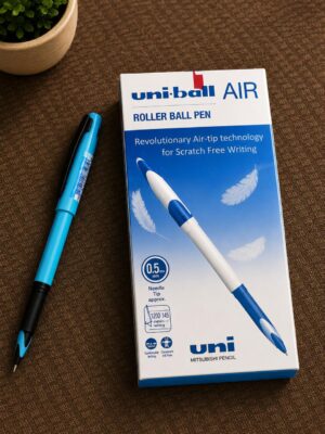 Box of uni-ball AIR roller ball pen with a blue pen beside it on brown fabric; visible text reads 'uni-ball AIR' and 'ROLLER BALL PEN'.