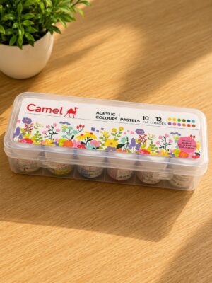 Camel acrylic paints in a clear plastic case on a wooden table, lid featuring colorful flowers and brand logo.