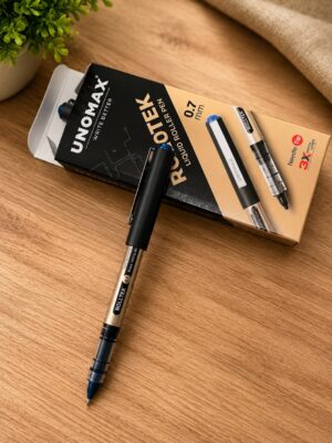 Roller pen with gold and black body placed on a beige box on a wooden desk, with a small green plant in the background as context.