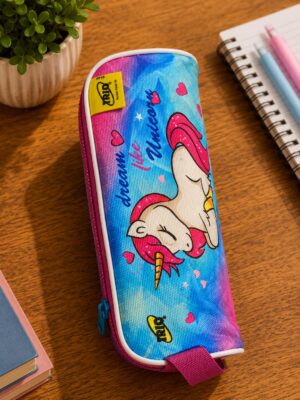 Colorful unicorn-themed pencil case on a wooden desk beside a notebook and a small plant.