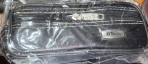 Black textured zippered pouch in plastic wrap, with a metal brand badge reading 'Twinkle'.