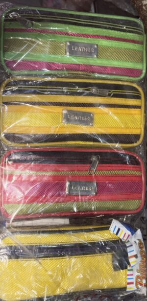 Colorful zippered pouches stacked in plastic packaging; green, yellow, pink, and orange with metal LEATHER labels