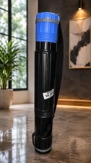 Tall black cylindrical container with a blue cap and carrying strap, standing upright in a modern living room showroom area.
