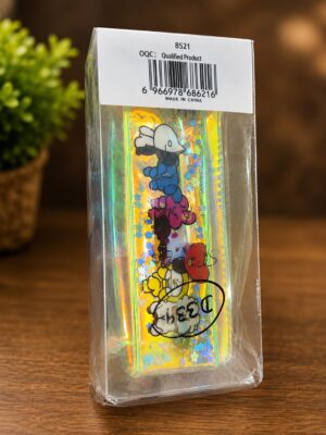 Clear plastic packaging around a holographic, colorful cartoon item with characters and a barcode on a white label at the top.