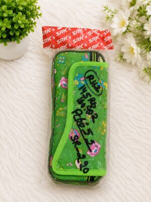 Green floral pencil case with bright lime-green trim, in clear plastic packaging on a white furry surface with white flowers nearby.