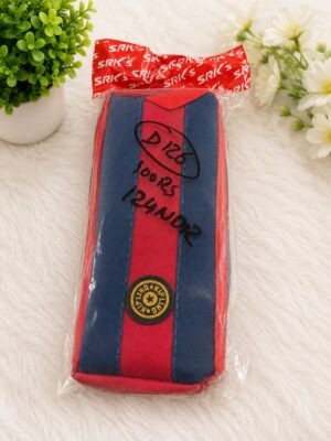 Pencil case with red central stripe and blue sides, sealed in plastic on a white furry surface.