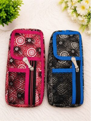 Two patterned zippered pouches side by side on a soft white surface, one red with pink trim and one black with blue trim.