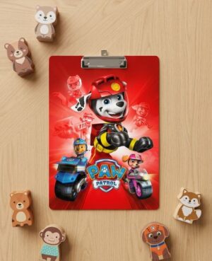 Clipboard with a red Paw Patrol poster on a wooden floor, surrounded by small wooden animal figurines.