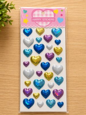 Sticker sheet featuring multiple metallic heart-shaped stickers in blue, gold, silver, pink, and teal on a white background with pink packaging that reads 'Happy Stickers'.