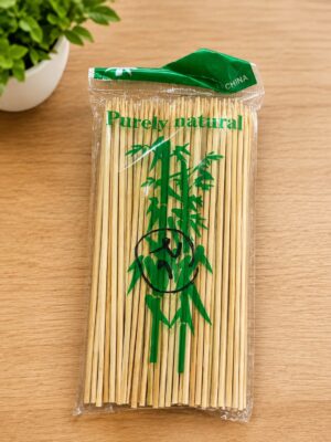 Pack of wooden chopsticks in a clear plastic wrapper with a green bamboo graphic and 'Purely natural' text on top edge.