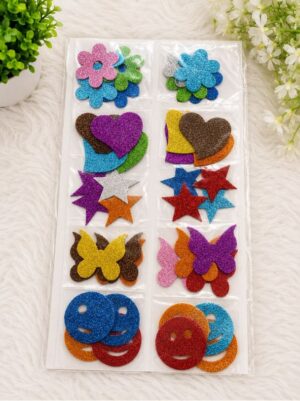 Assorted glitter foam shapes in a plastic organizer: flowers, hearts, stars, butterflies, and smiley faces for crafts, on a white fuzzy background.