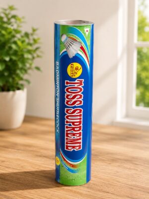 Tall blue cylindrical tin labeled 'Badminton Shuttlecock' with a shuttlecock graphic, standing upright on a wooden table indoors, plant and window in background.
