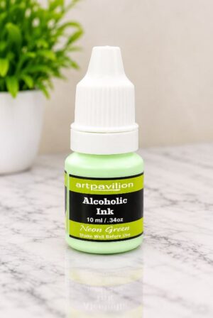 Neon green alcohol ink bottle with white cap on marble, labeled artpavilion.