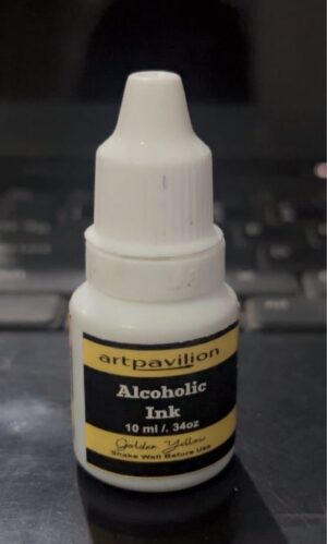 White dropper bottle of Artpavilion Alcohol Ink in Golden Yellow (10 ml) on a dark surface with a labeled black-yellow label and cap