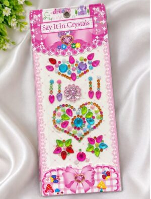 Packaging for 'Say It In Crystals' gem sticker kit with colorful rhinestones arranged into hearts and floral shapes on a pink card.