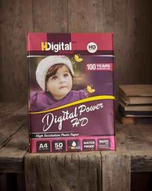 Box of Digital Power HD high-resolution photo paper on a wooden table, featuring a baby's portrait on the packaging.
